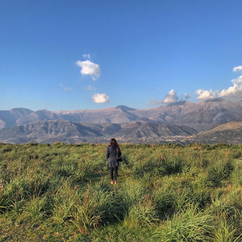 woman in area in albania with hills