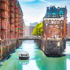 Classic view of famous Hamburg Speicherstadt warehouse district with sightseeing tour boat on a sunny day in summer, Hamburg, Germany