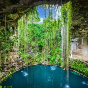Ik-Kil Cenote, Mexico. Lovely cenote in Yucatan Peninsulla with transparent waters and hanging roots. Chichen Itza, Central America.