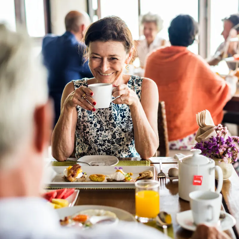 Couple Easting Breakfast At Hotel