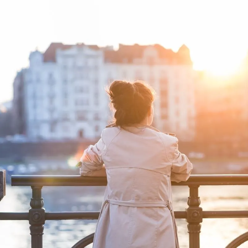 Woman looking at sunset in prague