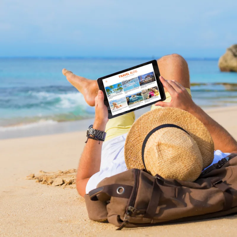 traveler on beach with iPad