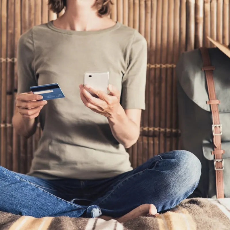 Traveler Holding Up a Credit Card