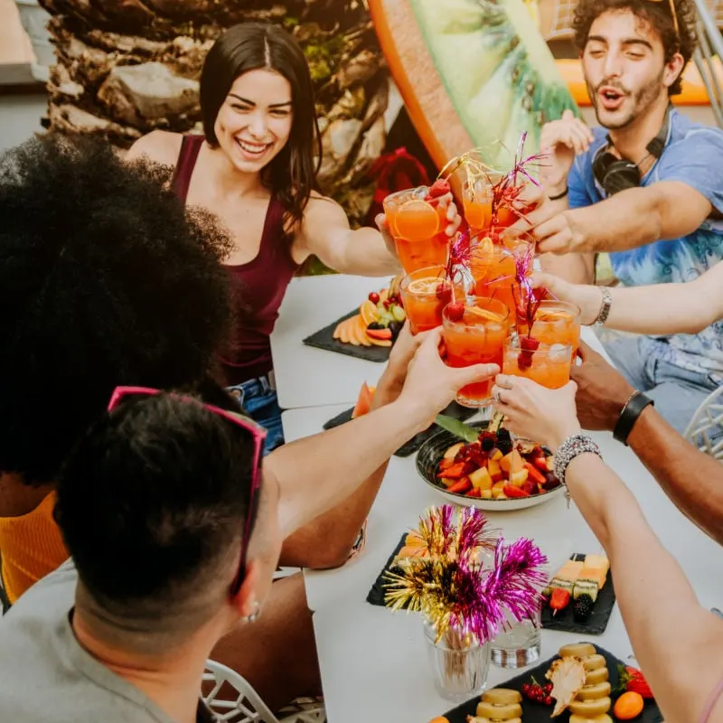 diverse friends celebrating with good food and drinks