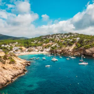 Aerial view of the cliffs and the beach of Cala Vadella, Ibiza, Spain.