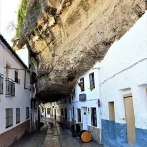 Narrow Street Lined With Whitewashed Houses Built Under A Rock Overhang In Setenil De Las Bodegas, Andalusia, Spain