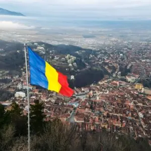 Romanian Flag Flying Over A Mountaintop In Romania, Balkan Peninsula, Eastern Europe