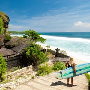 A surfer overlooking a beach in Bali