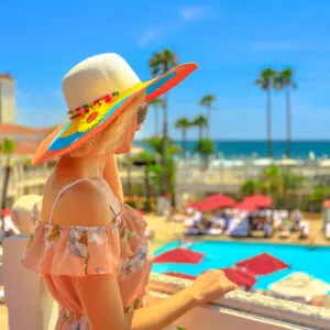 Woman looking out over pool in San Diego, California