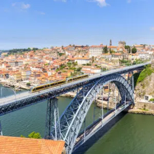 train crossing bridge in porto portugal