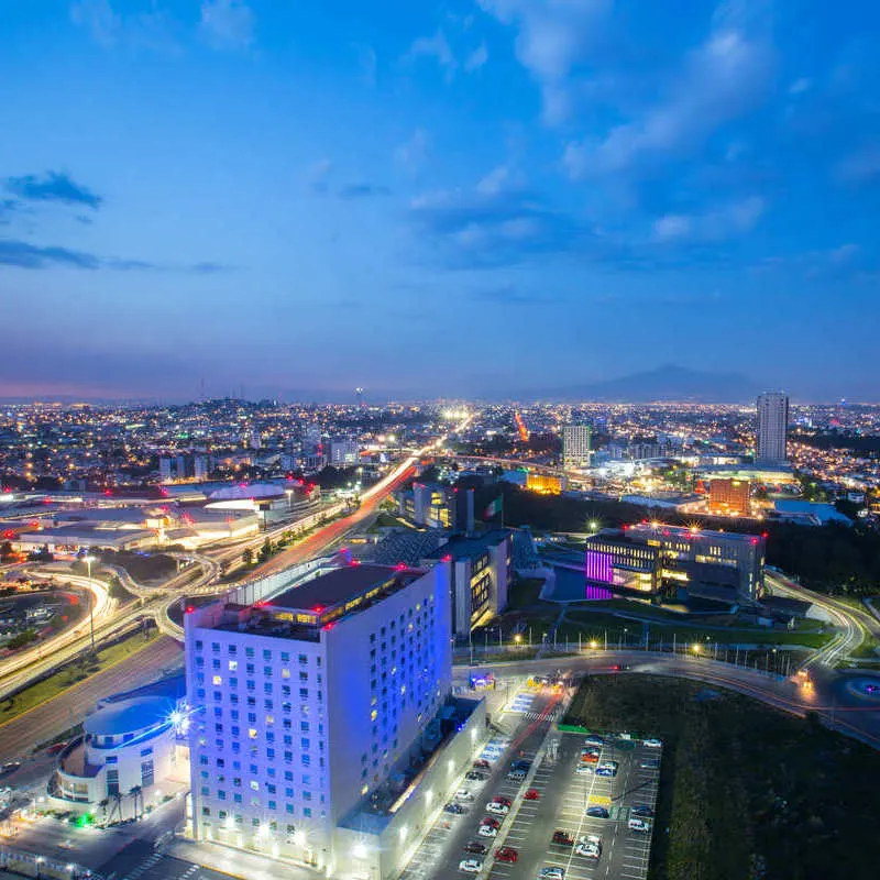 Aerial View Of Angelopolis, A Modern District Of The Historical City Of Puebla Seen At Nighttime, Central Mexico, Latin America