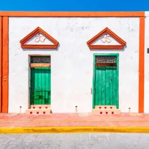 White House With Orange Doorframes And Vibrant Green Doors In Campeche, Mexico