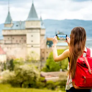 Woman looking at a castle in Slovakia, a female solo traveler