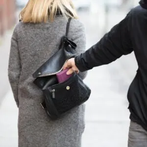 pickpocket stealing a purse