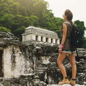 A Young Female Backpacker Exploring A Mayan Ruin In Mexico, Latin America