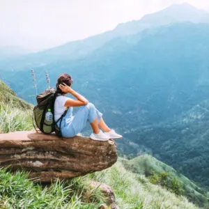 woman enjoying the beautiful view on mountains and valley in Ella, Sri Lanka