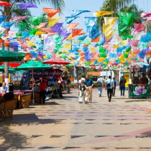 TIJUANA People shop and dine at Plaza Santa Cecilia, a historic Mexican square with colorful hanging flags