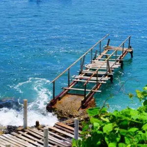 A Wooden Pier Stretching Into The Pacific Ocean On An Island Off The Coast Of Rincon de Guayabitos, Mexican Pacific, Mexico