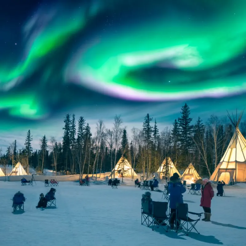 people looking at the Northern Lights in Yellowknife, Canada