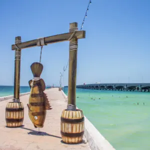 Fish statue and view of the longest pier in the world. The port city of Progreso, near Merida, Yucatan
