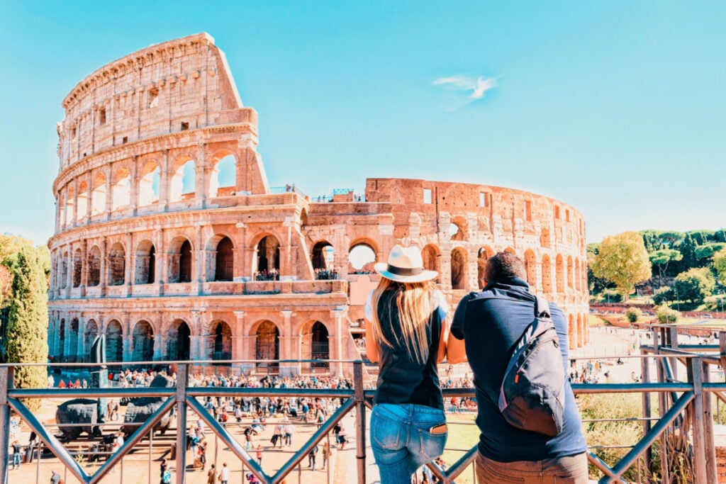 Two American Travelers overlook  Rome Colosseum 
