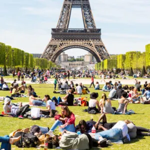 large crowd of tourists next to the eiffel tower in paris