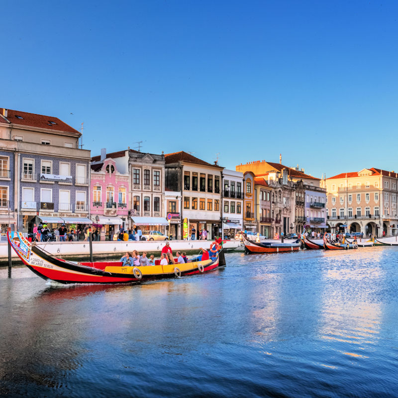 Central Canal In Aveiro With Traditional Boat Moliceiro To Transport central-canal-in-aveiro-with-traditional-boat-moliceiro-to-transport