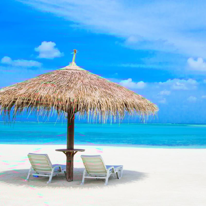 MaldivesBeachwithumbrellaandchairs Travel Off Path