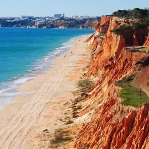 aerial view of orange cliffs on the beach at praia da falesia in the algarve portugal