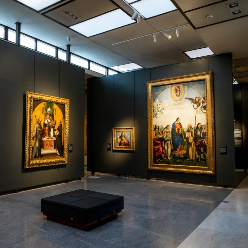People watch the paintings inside the National Gallery of Bologna