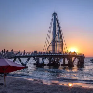 the famous los muertos pier in puerto vallarta at sunset