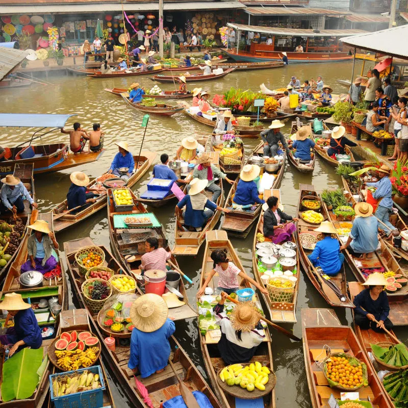 Vendors at floating market in Thailand