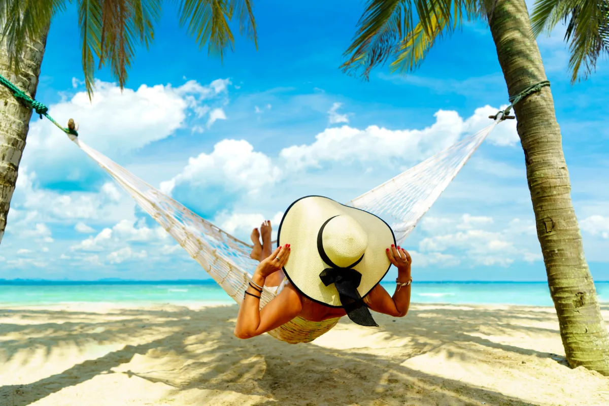 Woman relaxing on a hammock at the beach