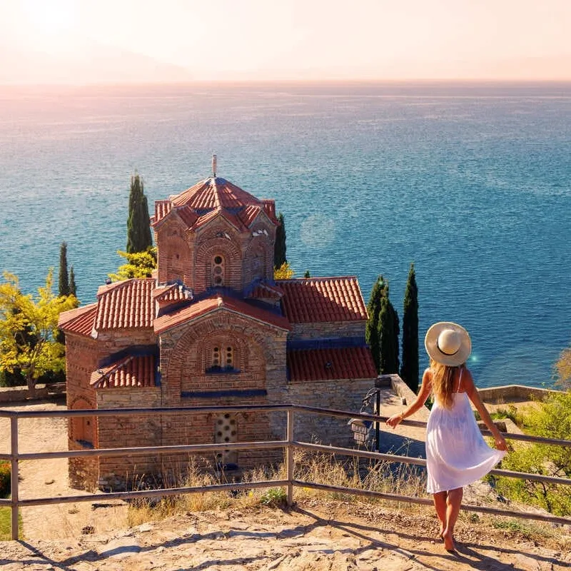 Young Woman Admiring A View Of An Old Byzantine Church In Ohrid, North Macedonia