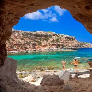 Young Women Sunbathing In A Beach In Formentera, Spain, Mediterranean