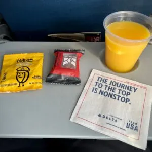 airline snacks and orange juice served on a Delta Airlines flight