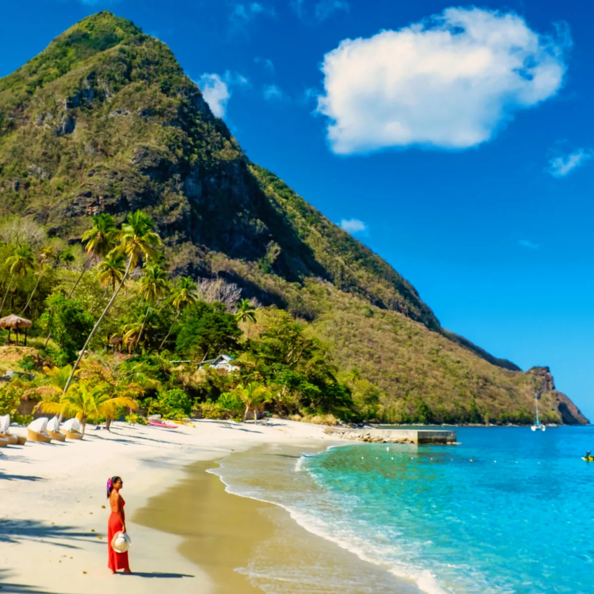 Why Tourists Are Flocking To This Beautiful & Tiny Caribbean Island Right Now Woman on a beach in Saint Lucia