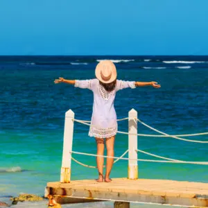 Woman standing on a pier enjoying the sea views