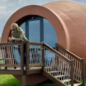 Young Blonde Man With Long Hair Admiring The View From The Balcony Of His Amphora Shaped Room In Hotel Qvevrebi, Georgia, Eurasia