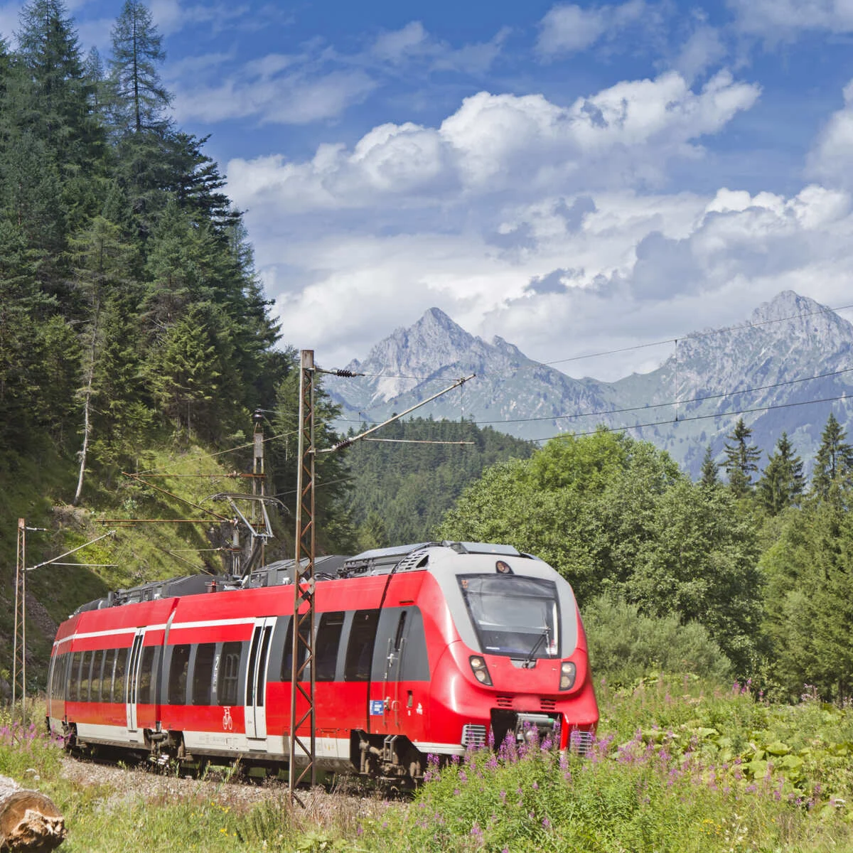 A Red OBB Train Traversing The Austrian Alps In Europe