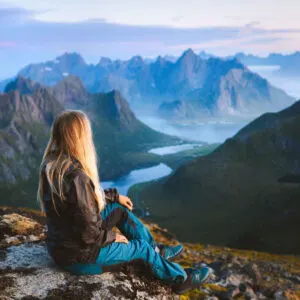 Solo female traveler enjoying the mountains and landscape in Norway