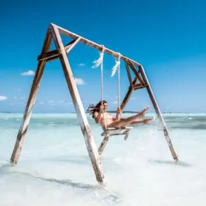 Woman on a beach swing in the Bahamas