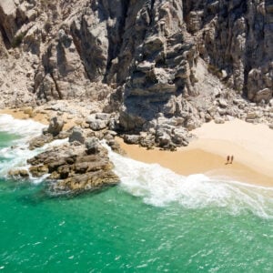 Aerial Image of couple standing on Playa de los Almantes in Cabo San Lucas, Baja California, Mexico