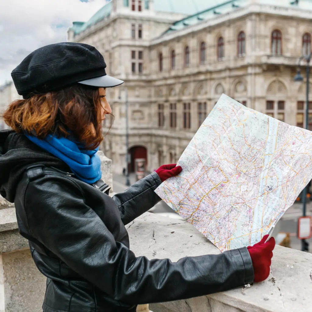 Woman In A Coat Reading A Map In Vienna, Austria