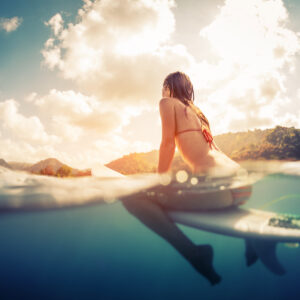 Woman surfing on a beach in Costa Rica