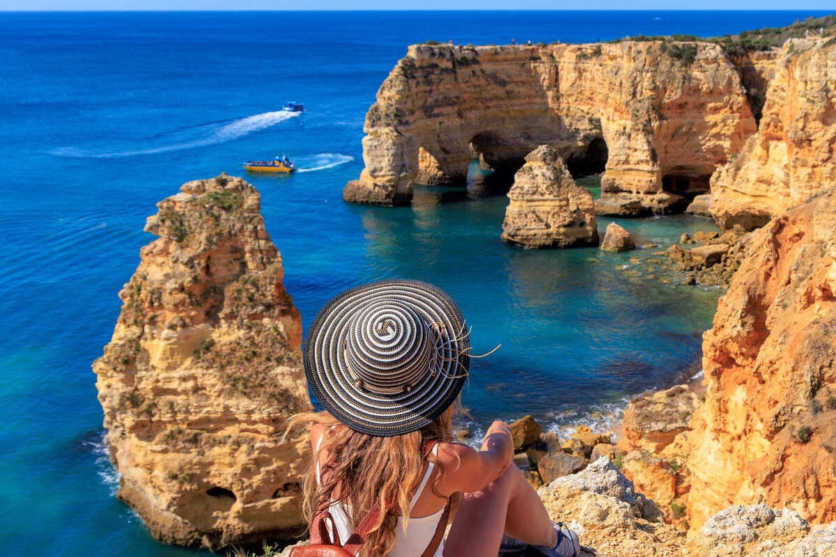 Young Woman Admiring A View Of The Algarve Coast In Portugal.jpgYoung Woman Admiring A View Of The Algarve Coast In Portugal