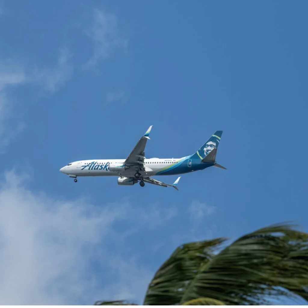 An Alaska Airlines flight in a clear blue sky