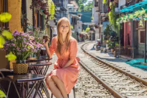 Solo traveler at Hanoi cafe next to train tracks