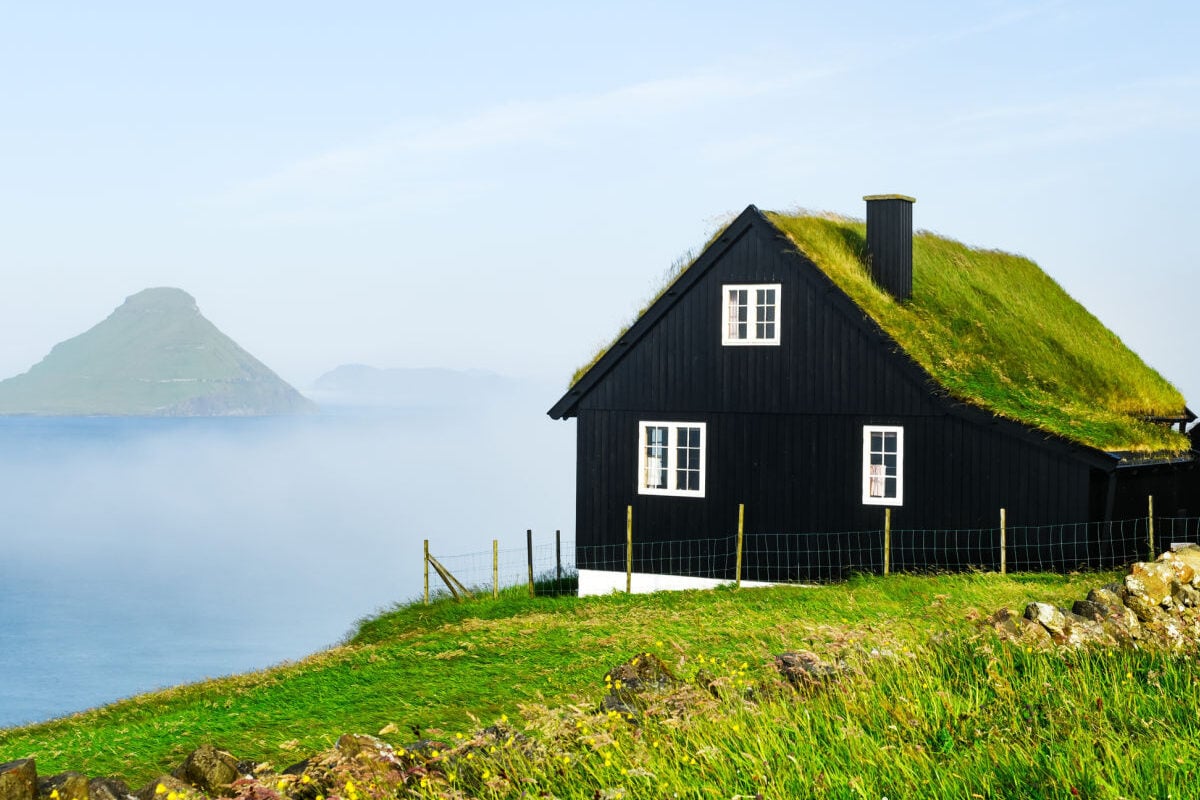 Cliffside-traditonal-sod-roofed-home-in-Faroe-Islands