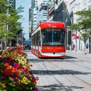 Red Tram Traveling Through The Streets Of Downtown Toronto, Canada
